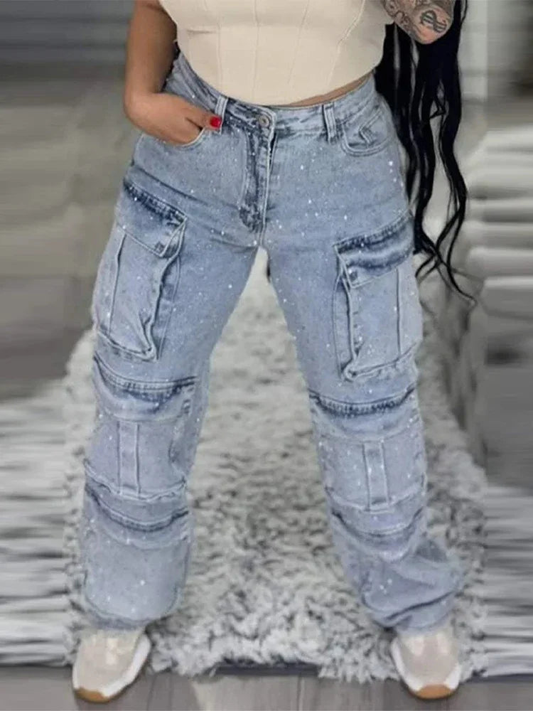 Front view of high-waisted rhinestone Light Blue jeans with polka dots, worn by a fashion model at Home.