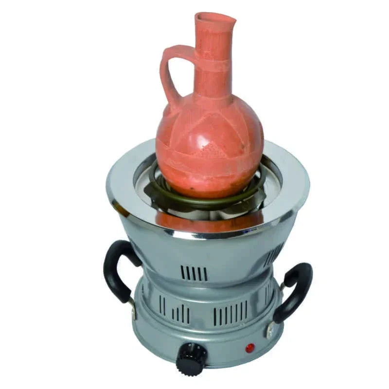 Small stove with a ceramic pot on top against a white background