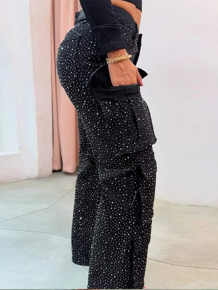 Side view of high-waisted rhinestone Black jeans with polka dots, worn by a fashion model at Home
