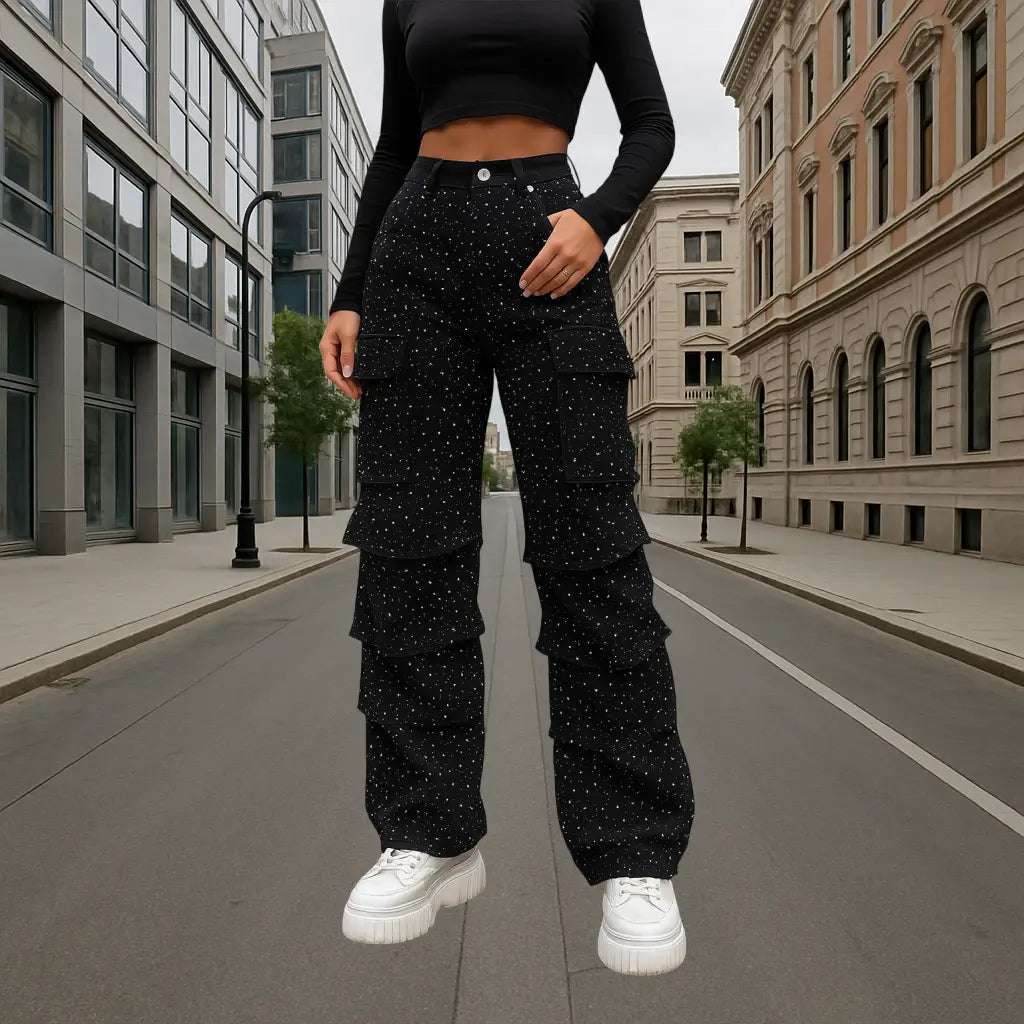 Woman wearing high-waisted black rhinestone jeans with layered ruffle design and white polka dots, street-style fashion