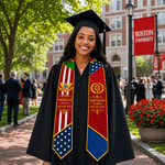A smiling woman in a black graduation cap and gown stands outdoors on a campus walkway, wearing a decorative stole with American and British/Indian graduate emblems and flag panels. Trees, brick buildings, and a red Boston University banner are visible in the background.